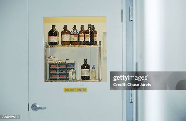 laboratory bottles in restricted room of lab - zugangsbeschränkung stock-fotos und bilder