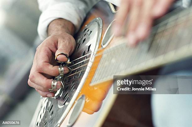 man playing guitar, focus on hands - gitarrplektrum bildbanksfoton och bilder