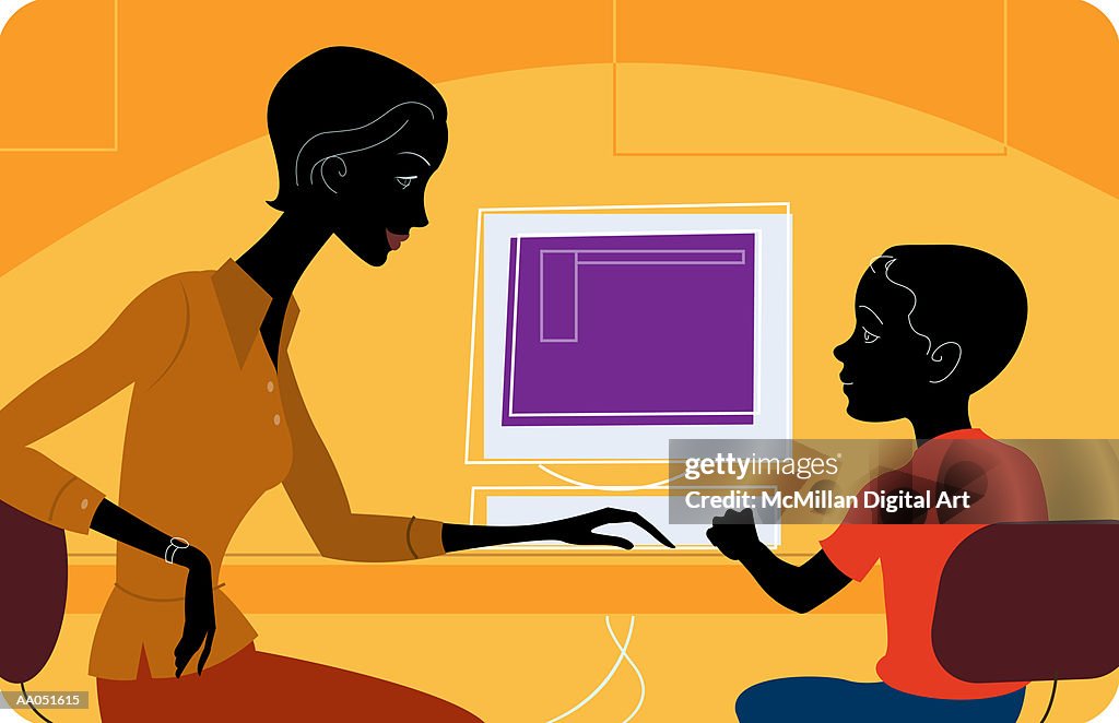 Woman Helping Boy Use Computer