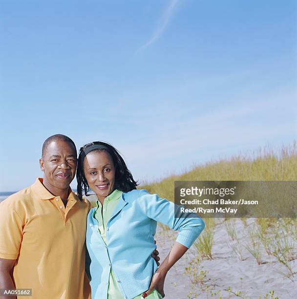 man and woman standing on beach, smiling, portrait, washington, usa - baker beach stock pictures, royalty-free photos & images