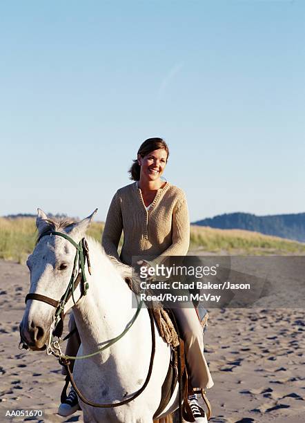 woman riding horse on beach, washington, usa (selective focus) - baker beach stock pictures, royalty-free photos & images