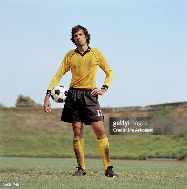 soccer player standing with ball - physical position stock pictures, royalty-free photos & images