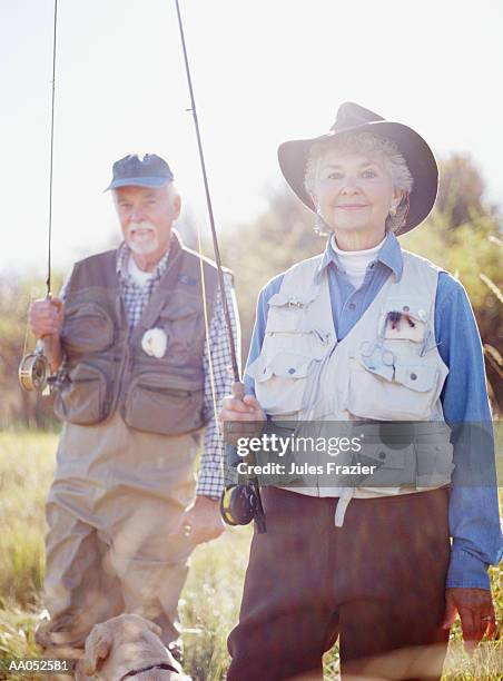 elderly couple with fishing gear, outdoors - fiskeväst bildbanksfoton och bilder