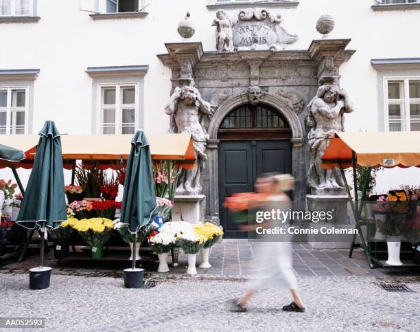 young woman selling flowers, outdoor market, slovenia (long exposure) - connie stock pictures, royalty-free photos & images