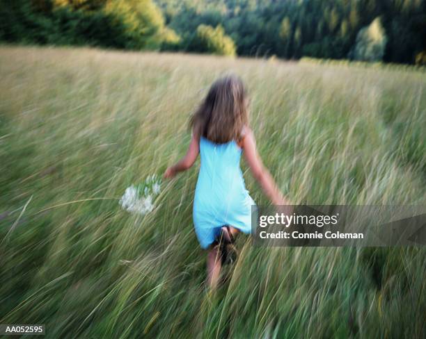 girl (8-10) running through field, summer, rear view (panning) - connie stock pictures, royalty-free photos & images