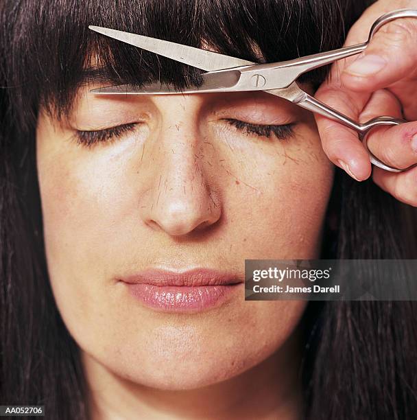 woman getting bangs cut, eyes closed, close-up - fringe stock pictures, royalty-free photos & images