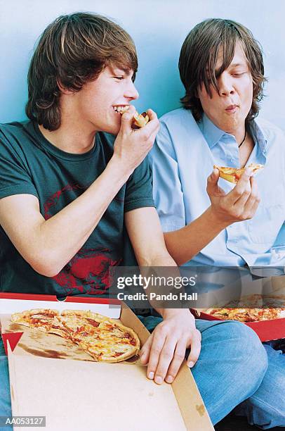 young men eating pizza from cardboard boxes - super sensory stock pictures, royalty-free photos & images