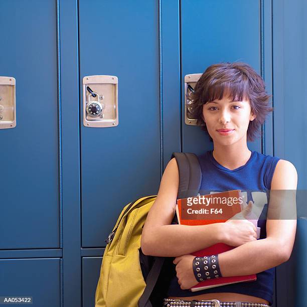 teenage girl (15-17) leaning against lockers, portrait - f 16 stock pictures, royalty-free photos & images