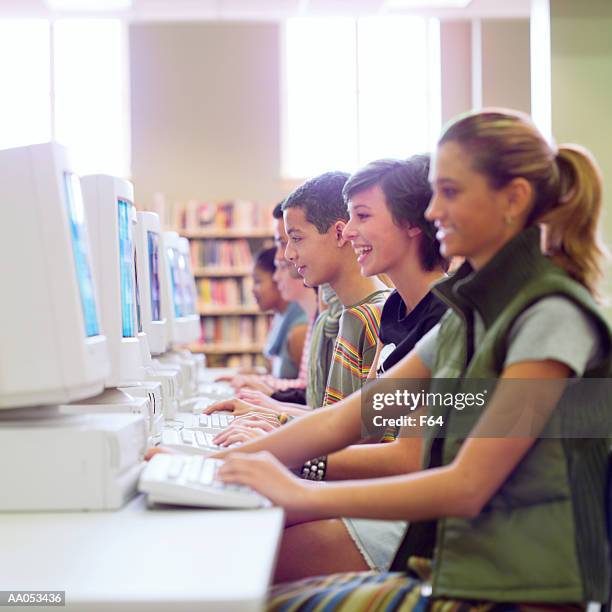 group of high school students using computers in school library - f 16 stock pictures, royalty-free photos & images