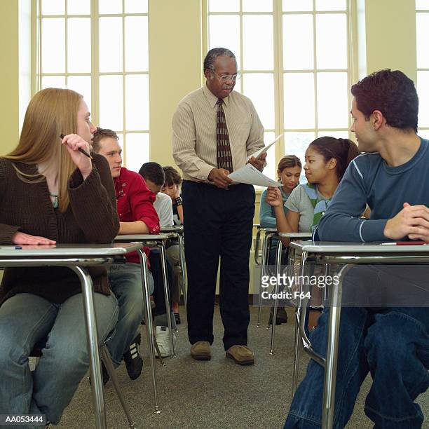 teacher returning tests to students, high school classroom - f 16 stock pictures, royalty-free photos & images