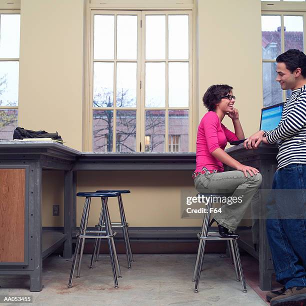 teenage girl and boy (16-18) talking, high school classroom - f 16 stock pictures, royalty-free photos & images