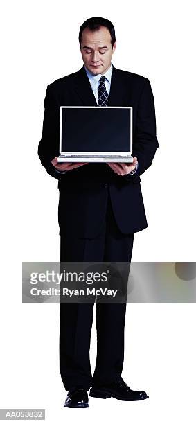 businessman holding laptop, looking at screen - buisnessman studio clipping path bildbanksfoton och bilder