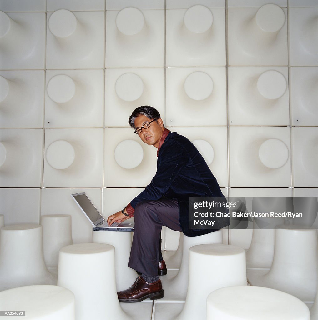 Businessman using laptop computer, side view