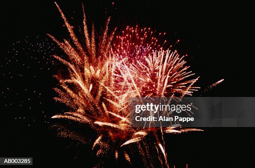 Fireworks exploding, night, low angle view Fireworks exploding, night, low angle view