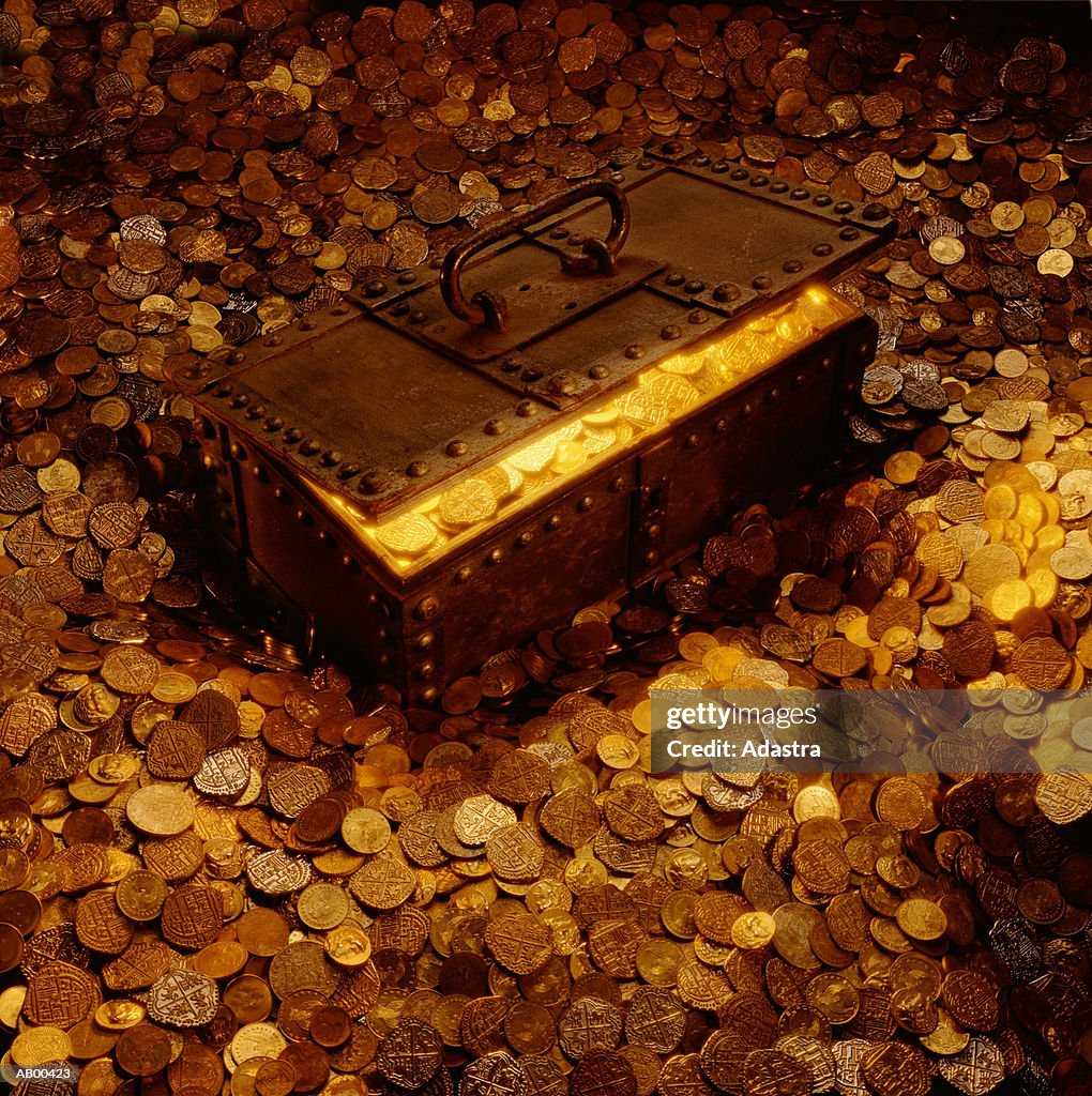 TREASURE CHEST SURROUNDED BY AND FULL OF COINS