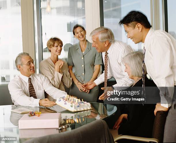 businesspeople throwing birthday party in office - throwing cake stock pictures, royalty-free photos & images