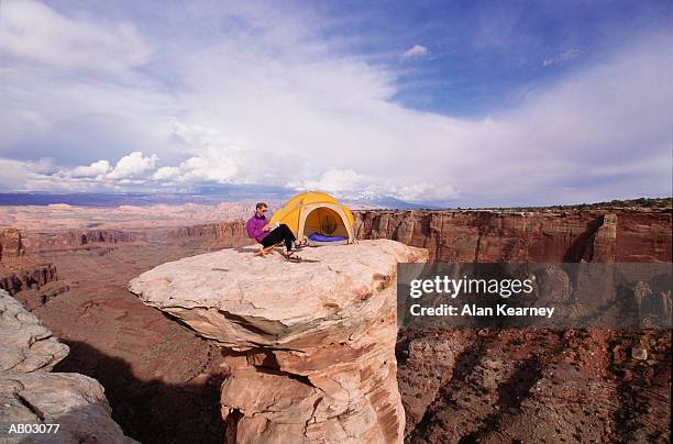 male camper reading book on pinnacle - pinnacle imagens e fotografias de stock