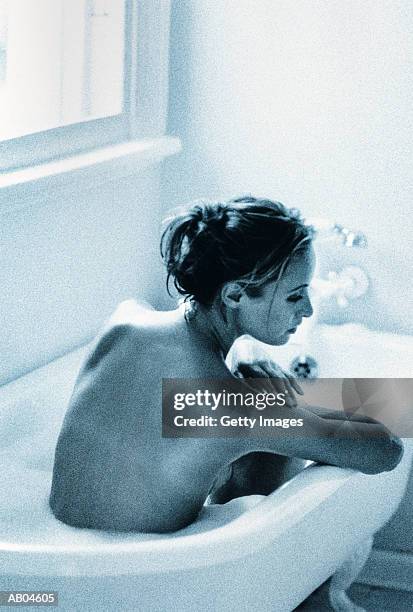 woman taking bath - baignoire sur pieds photos et images de collection