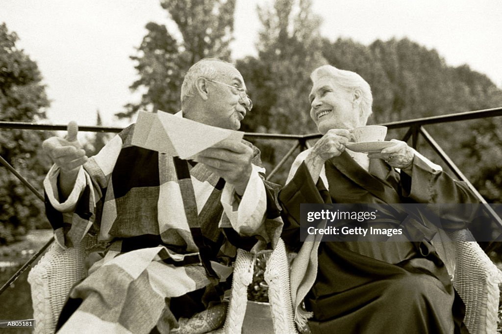 Elderly couple in robes sitting in balcony