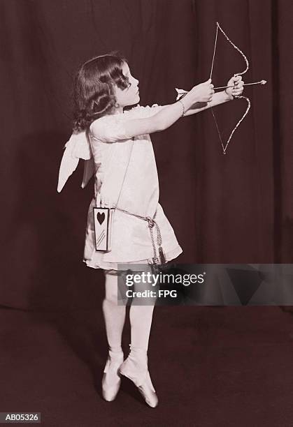 girl ballerina dressed as cupid with bow and arrow - cupid stock pictures, royalty-free photos & images