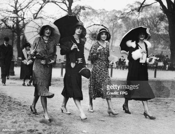 group of women walking with umbrellas / circa 1930's - 1930s imagens e fotografias de stock