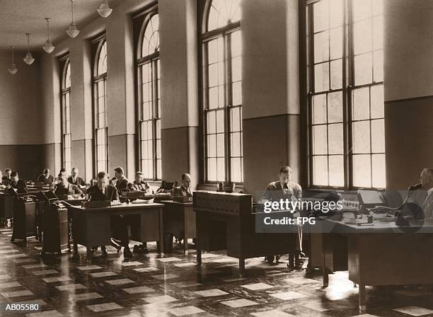 archive shot / office scene / workers talking on dictaphones - 1950 stock pictures, royalty-free photos & images