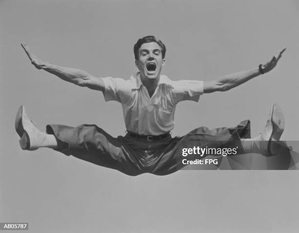 man jumping in air, doing split (b&w) - archive 2005 foto e immagini stock