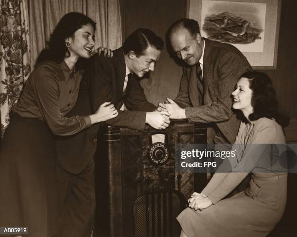 two couples listening to radio, smiling (b&w sepia tone) - archive 2005 stock-fotos und bilder