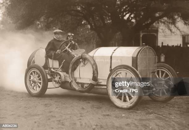 two men driving race car (b&w sepia tone) - vintage car stock pictures, royalty-free photos & images