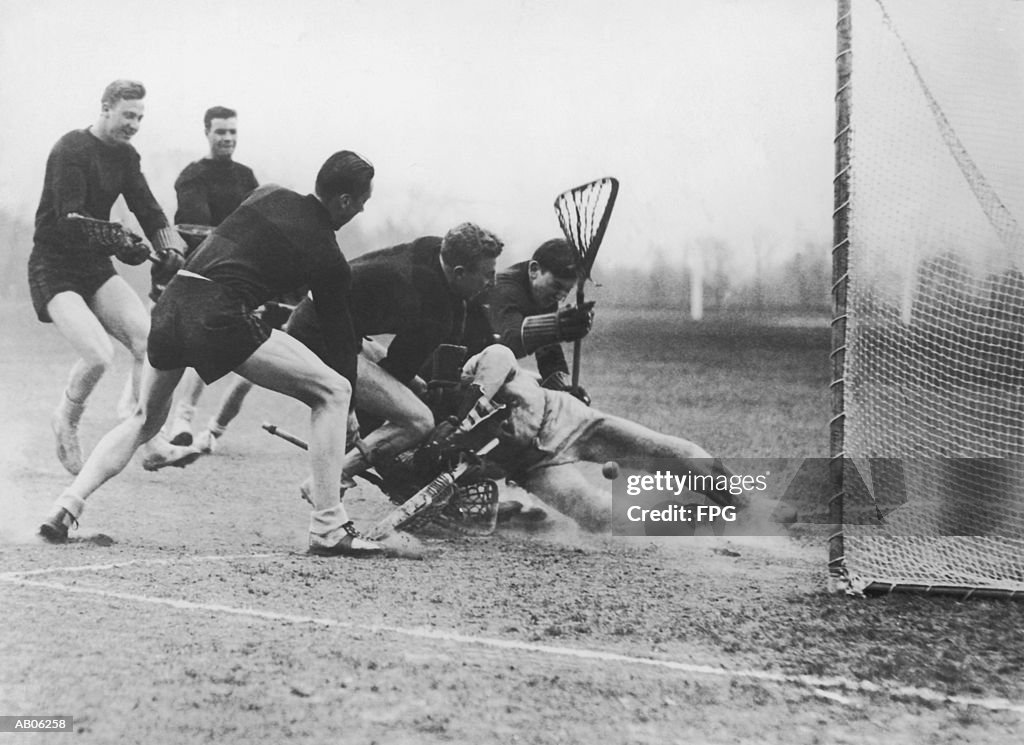 Men playing lacrosse (B&W)