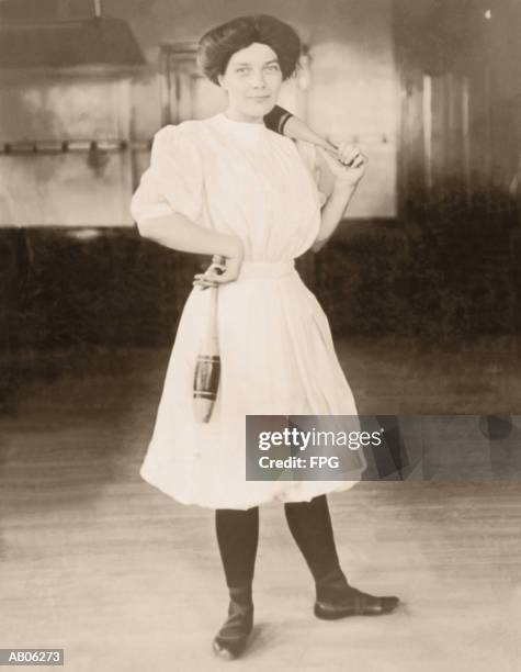 young woman holding exercise pins (b&w sepia tone) - juggling pin stock pictures, royalty-free photos & images