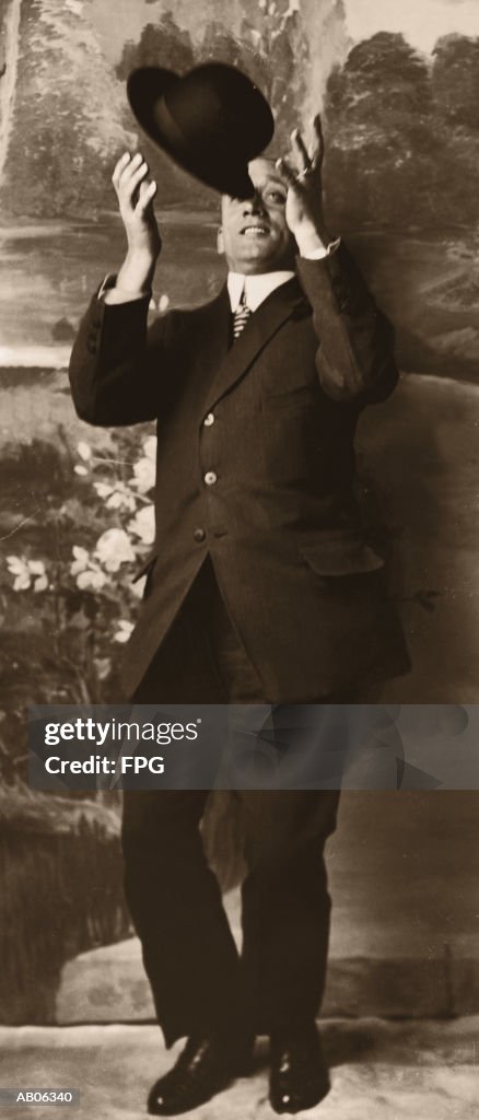 Man catching hat (B&W sepia tone)