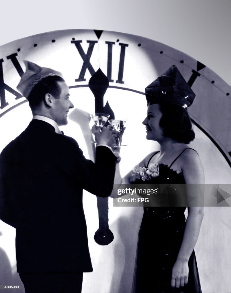 Couple in formal wear celebrating New Year (B&W)