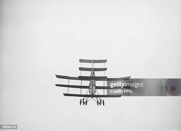 triplane flying, rear, low angle view (b&w) - 20th century stock pictures, royalty-free photos & images