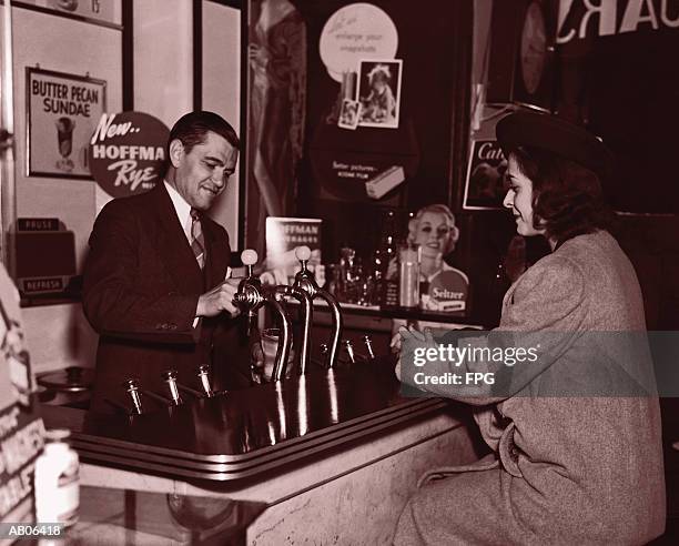 man serving woman at soda fountain (b&w sepia tone) - soda bildbanksfoton och bilder