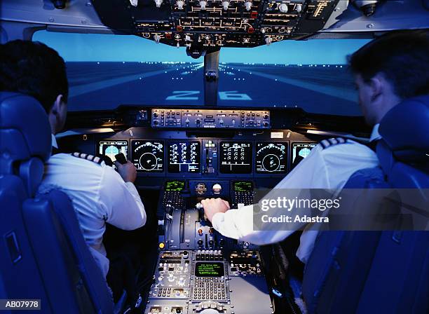 pilot and co.pilot in flight simulator/mc donald douglas md11 - pilot plane stock pictures, royalty-free photos & images