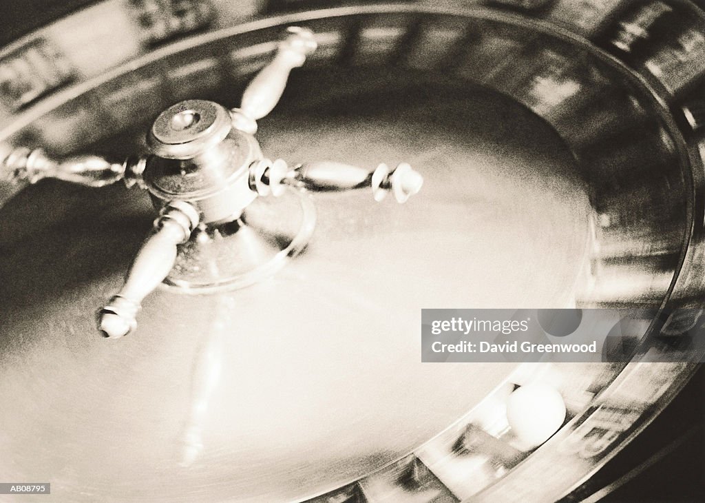 Roulette wheel, close-up (blurred motion, B&W)