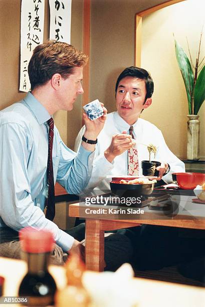 two businessmen in oriental restaurant - oriental stock pictures, royalty-free photos & images