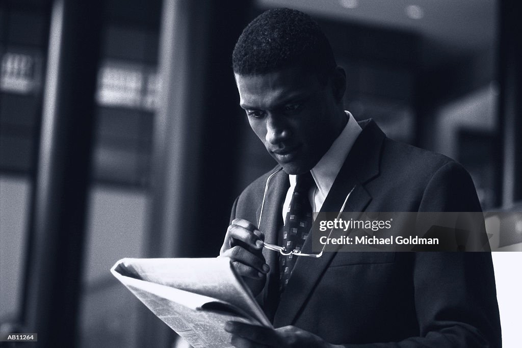 Businessman reading newspaper (Toned B&W)