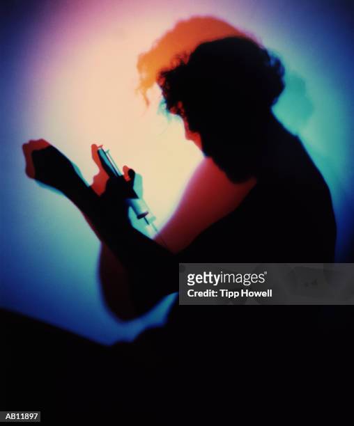 man injecting himself, silhouette (multiple exposure, gel effect) - shooting up fotografías e imágenes de stock