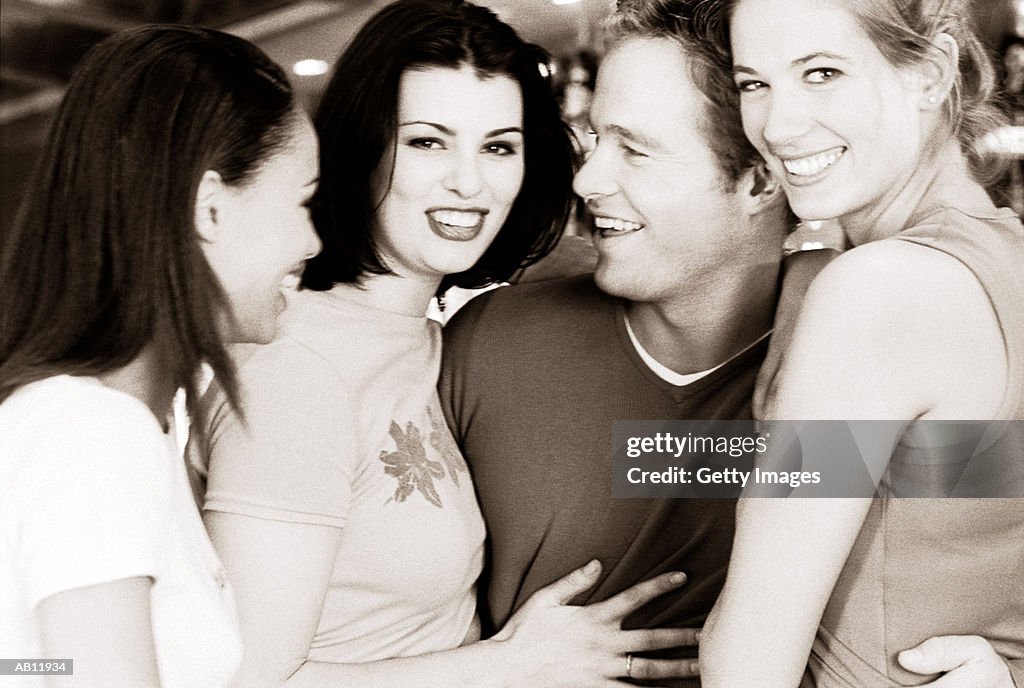 Man with three women in bar, (B&W)