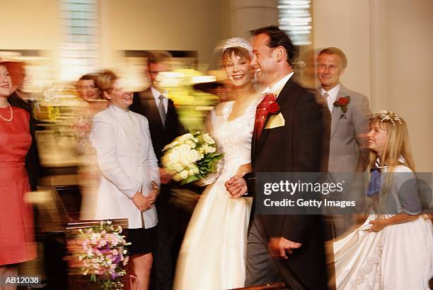 bride and groom leaving church alter as newlyweds, guests smiling - wedding ceremony alter stock pictures, royalty-free photos & images