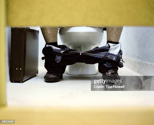businessman sitting on toilet, low section (wide angle) - pants down bildbanksfoton och bilder