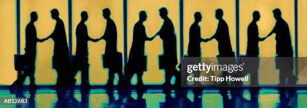 businessman shaking hands (digital composite) - handshake silhouette stock pictures, royalty-free photos & images