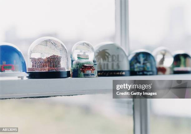 snow globes on windowsill - snow globe stock pictures, royalty-free photos & images