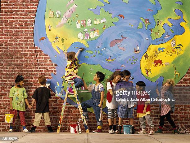 children (5-7) painting an earth mural - elementary school building stock pictures, royalty-free photos & images