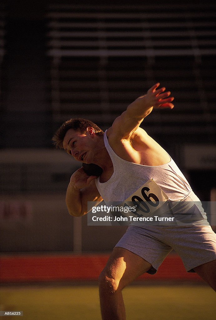 Male shot putter in action