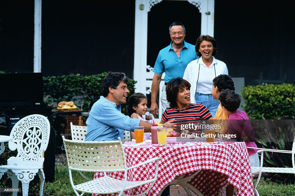 Generational family dining in garden