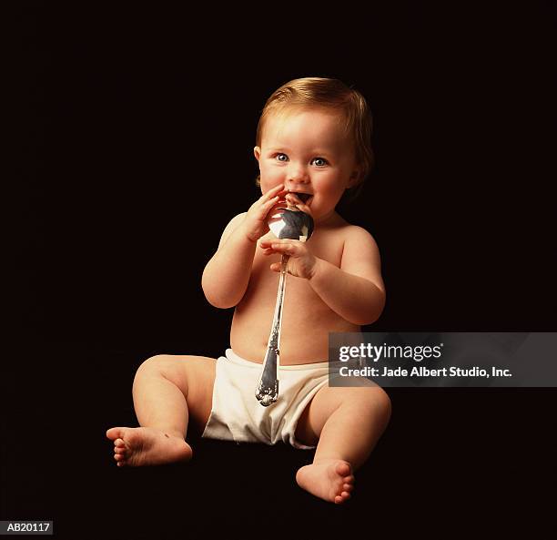 baby (6-9 months) with silver spoon in mouth - silver spoon in mouth stock pictures, royalty-free photos & images