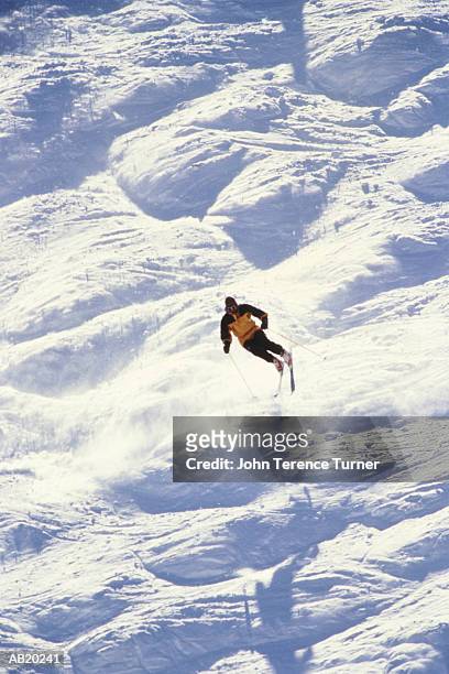 man downhill skiing over moguls - pitkin county stock pictures, royalty-free photos & images